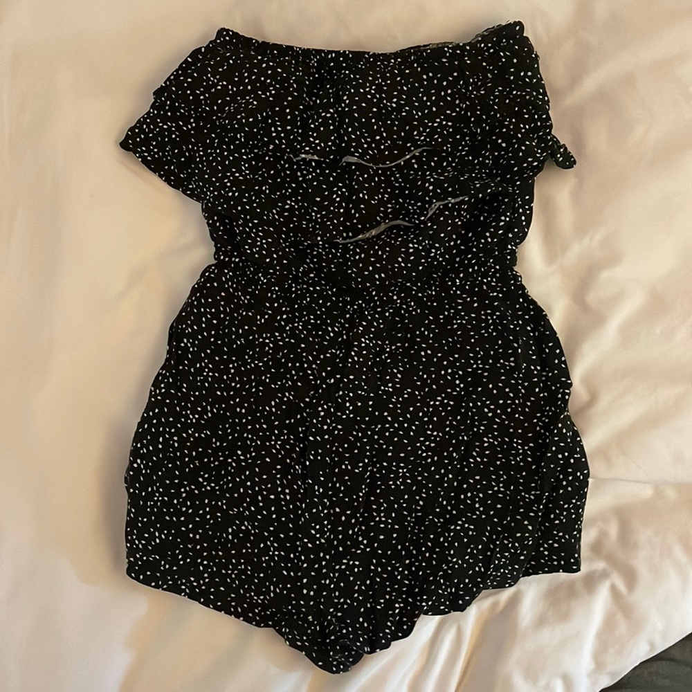 Adorable sleeveless romper with ruffle design on the top